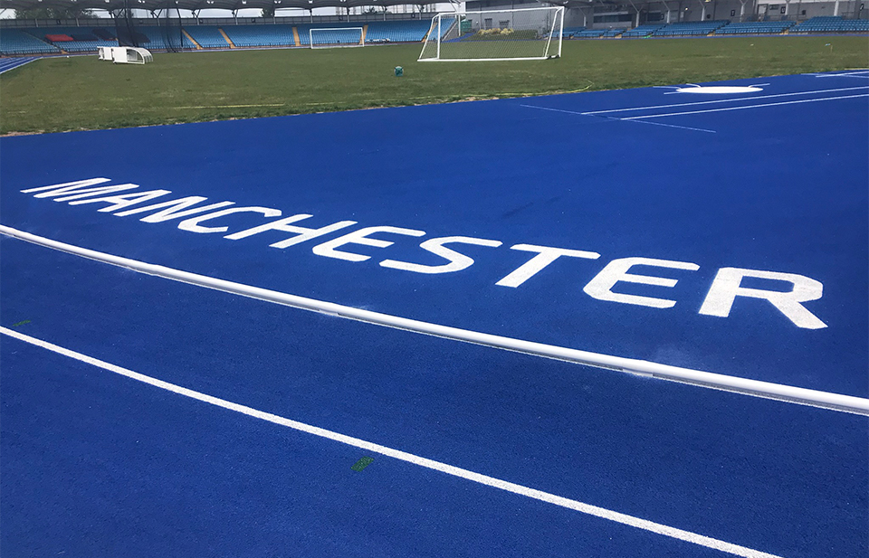 Image of a professional running track branded 'Manchester'
