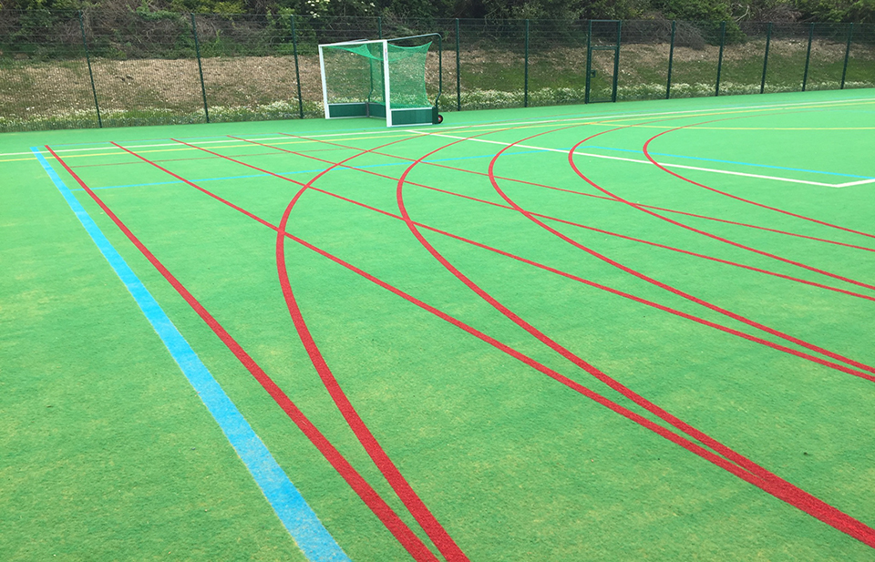 Image of track lanes painted on artificial grass